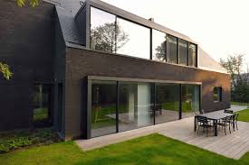 Modern brick house living room, american kitchen with pantry, 4 bedroom, 2 bathroom, workroom, laundry, 3 balcony, 2 big terrace, carpark, garden #american_kitchen #architecture #balcony #bath #bedroom #brick #carpark #fence #furniture. This Contemporary Black Brick House Was Renovated For A New Life In Belgium