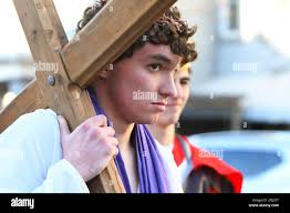 Jesus, portrayed by Jacob Irvin, carries the cross during the Living  Stations of the Cross presented by A.C.T.I.O.N. (Active Christian Teens in  Our Neighborhood) in Mahanoy City, Pa.,