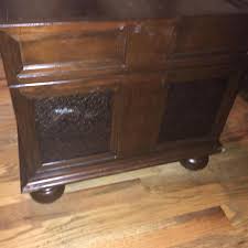 The rich brown finish is beautifully complemented with the old world look of inset stamped metal elements and buckle belt accents to create an. Ashley S Mckenna Storage Cocktail Trunk Table Aptdeco