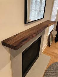 Our traditional shelves are available in a variety of wood types including: Live Edge Floating Shelf Solid Black Walnut Complete Kit Etsy In 2021 Live Edge Shelves Wood Mantle Fireplace Floating Fireplace