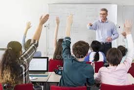 Maybe you would like to learn more about one of these? Male Teacher Calling On Students In Classroom Sitting Gesturing Stock Photo 202436464