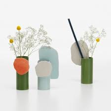 Cheap ordinary glass vases turned into crafty patterned vases with removable wallpaper and gold foil. Vases Dezeen