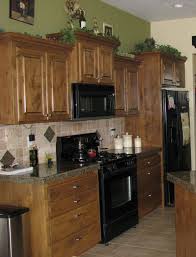 Sage Green Wall Paint Brown Wooden Kitchen Cabinet And Beige Tile Backsplash Green Kitchen Walls Sage Green Kitchen Walls Kitchen Design Decor