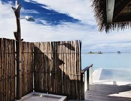 Tropical outdoor garden shower this outdoors shower is actually set under an open roof of sorts, but it is meant to feel like bathing on a waterfall. Tropical Outdoor Bathroom Luxury Bathrooms