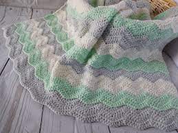 Check out the best gender neutral crochet baby blanket roundup around! Baby Blanket Crochet Mint Nursery Decor Crochet Baby Blanket In Mint Gray And Ivory Travel Size Chevr Baby Blanket Crochet Crochet Baby Baby Nursery Neutral