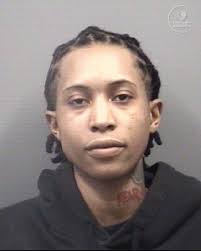 Name: Shelia Monet Teamer Age/Gender/Race: 20/Female/Black Arrest Date:  03/22/2025 Charges: 1. Discharging a Weapon into an Occupied Dwelling or  Moving Vehicle 2. Discharging a Firearm in City Limits