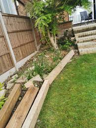 You can add a sleek, curved and organic feel to your garden as shown in the below image where curved wooden panels have been used to provide a sleek and modern touch to a garden. Edging Ideas For Sloping Garden Around Acer Bbc Gardeners World Magazine