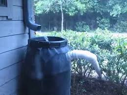 A simple barrel rainwater system that has been disguised with paint and decorated with beautiful stones and plants. Rain Barrel Overflow Pipe Youtube