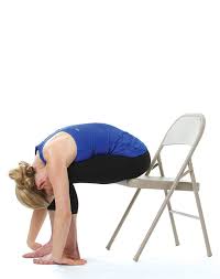12 Chair Yoga Poses For Stress And Posture Purewow Chair Yoga Yoga Poses Chair Pose Yoga