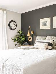 The bedding is decorated with catchy red linens and throw pillows. The Best Home Decor Items To Buy Secondhand Modern Farmhouse Master Bedroom Modern Farmhouse Style Bedroom Farmhouse Style Bedroom Decor