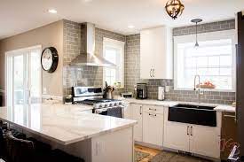 Our company specializes in custom countertops! Grey And White Kitchen With Granite Countertops White Cabinetry And Grey Subway Tile Granite Countertops Kitchen White Granite Kitchen Gray And White Kitchen