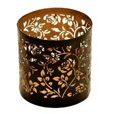Set of 3 metal candle holders featuring a striking laser cut design. Metal Tealight Votive Candle Holder