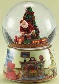 A snow globe (also called a waterglobe, snowstorm, or snowdome) is a transparent sphere, traditionally made of glass, enclosing a miniaturized scene of some sort, often together with a model of a town, landscape or figure. Animated Musical Santa Claus With Train Christmas Snow Globe Christmas Snow Globes Snow Globes Christmas Globes