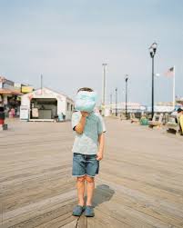 Young Boy Hiding Behind His Cotton Candy On A Jersey Shore Boardwalk By Cameron Whitman