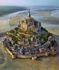 The Mont Saint Michel Is One Of Europe S Most Unforgettable Sights Set In The Mesmerising Bay Where Best Vacation Destinations Beautiful Castles Places To See