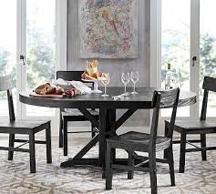 The table's rich stain hue highlights the wood's natural grain, creating a subtle sunburst effect. Benchwright Extending Pedestal Dining Table Blackened Oak Potterybarn Extendable Dining Table Round Pedestal Dining Dining Room Decor