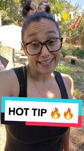 Lady Covering Plants with Umbrella from Hail