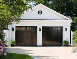 Black And White House With Wood Garage Door 9 Surprising Ways To Decorate With Black Garage Door Design Garage Doors Modern Garage Doors