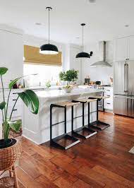 The sleek stainless steel appliances work well with polished wood countertops. Tour A Stylist S Mid Century Meets Traditional Farmhouse Full Of Thrifted Treasures Emily Henderson