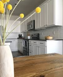Detail renovations classic kitchen with light yellow cabinetry and an immense central island topped with a granite counter. How To Make A Faux Brick Kitchen Backsplash The Blue Hue House
