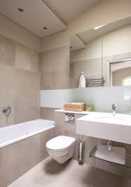 The wall art featuring a whale adds a touch of a nautical theme that's perfect for this space. Neutral Bathroom Houzz