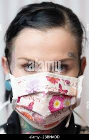 26 March 2020, Saxony, Zwickau: Daniela Beck, tattoo artist wears a  self-stitched mouth guard. Beck