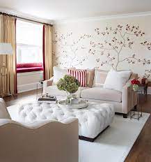 If you're still figuring out the vibe of the room, a camel leather square ottoman meshes well with any style. White Tufted Ottoman Contemporary Living Room Kim Scodro Interiors