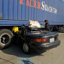 Crews rescue woman trapped under big-rig