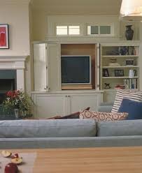 The defining elements of a storage cabinet are doors that protect the contents placed on interior shelves. Living Room The Tv Can Be Concealed With Retractable Doors So When Not It Use Can Be Hidde Built In Tv Cabinet Fireplace Built Ins Contemporary Family Rooms