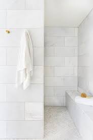 Brass Towel Hooks Are Fixed To Staggered Marble Bathroom Wall Tiles Over Marble Mosaic Floor Master Bathroom Shower Ann Sacks Tile Bathroom Bathroom Wall Tile