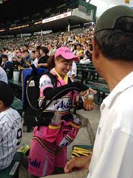 Hanshin Tigers And Tokyo Swallows Baseball Game In Osaka Japan A Worker Pours Beer From The Leg On Her Back Hanshin Tigers Japan Japan Travel