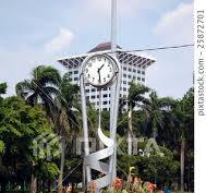 Flower bed with clock in Jakarta, Indonesia - Stock Photo ...