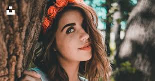 Woman wearing black bra and green see-through tank top leaning