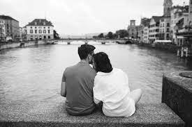 travel couple in zurich on the bridge by the zurich lake inspirational photo of cuople in romance couple travel photos travel couple pictures couples sitting