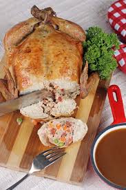 Place the chicken on a cutting board, with its backbone facing upwards. Rellenong Manok