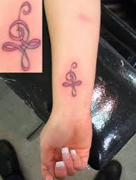 Cancer ribbon tattoo on wrist. Kent Tattoo Art Tattoo Designs By Arnold Doyle Pink Ribbon Tattoos Cancer Ribbon Tattoos Ribbon Tattoos