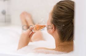 Placing your tub in its own nook creates a cozy spot for a good book, a glass of wine, and opt for a striking, unique bathtub that sets the tone for your entire design. Woman With Glass Of Wine Is Relaxing In Bathtub Rear Stock Photo Crushpixel