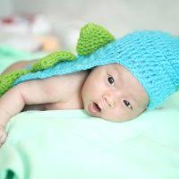 Kim Baughman, a registered nurse at the Naval Hospital Jacksonville  maternal infant unit, checks a newborn's reflexes.