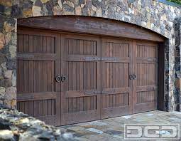 Montana rustics recognizes the past and seeks to honor their traditions in our garage door designs. This Tuscan Style Garage Door Was Handcrafted In Solid Rustic Alder Wood With An Oil Rubbed Finish A Garage Door Styles Garage Door Hardware Garage Door Design