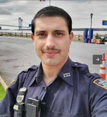 An NYPD police officer committed suicide yesterday at an apartment building  in Queens by leaping to his death in broad daylight.