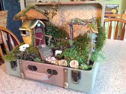 I Put Together A Fairy Garden In An Old Suitcase I Made The Fairy House From A Paper Mache Egg The Tops Of The Mushro Fairy Garden Diy Diy Fairy Fairy