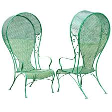 Pair Of Woodard Hollywood Regency Hooded Wrought Iron Arm Chairs 1stdibs Com Vintage Patio Wrought Iron Patio Chairs Wrought Iron Chairs