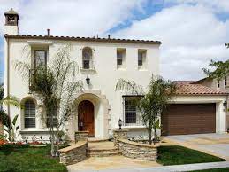 White spanish house featuring a blue front door and black shutters. Mediterranean White Stucco House Novocom Top
