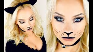 Angry black cat face with big eyes on the peach color background. 25 Cat Makeup Ideas For Halloween 2021 How To Do Cat Makeup Looks