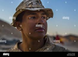U.S. Marine Lance Cpl Bryan Verduzco, infantry team leader with Fleet  Antiterrorism Security Team, guides a member of Gendarmerie through speed  reload training during Exercise African Lion 2018, in Tifnit, Morocco April