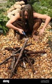 Cavewoman Makes Fire Stock Photo - Alamy