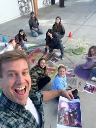Teacher creates Halloween chalk art with students