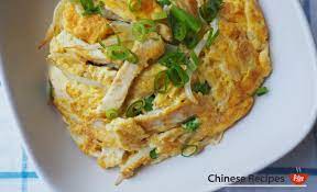 Portion of fried chinese omelet egg foo young served with a side. Recipe Egg Foo Young Chinese Omelette Assorted Bread Recipe