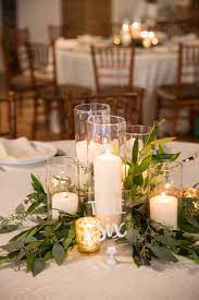 Match your style to one of these wedding centerpieces to bring your theme together place your favorite tomes in stacks on the center of the table, with or without details like flowers and candles. Charming Table Decor At Cannon Green In Charleston S C Photo Chelsea Paige Photography Candle Wedding Centerpieces Wedding Centerpieces Wedding Table
