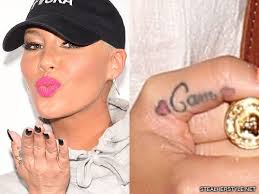 Amber and khalifa divorced but he has still got her name inked rose. Amber Rose S Cam Thumb Tattoo For Wiz Khalifa Steal Her Style